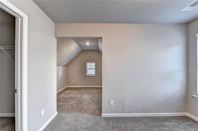 additional living space with carpet flooring and vaulted ceiling