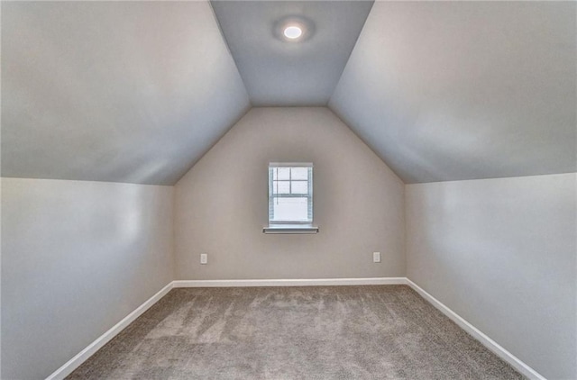 additional living space with light colored carpet and lofted ceiling