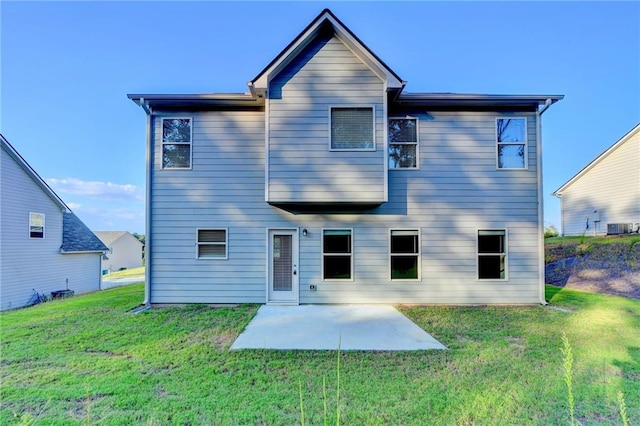 back of property featuring a patio area, a yard, and central AC