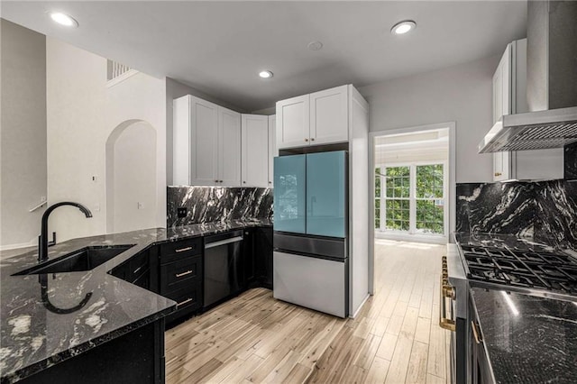 600 Oakmont Hl, Duluth, GA 30097 - kitchen with refrigerator, dishwasher, wall chimney exhaust hood, dark stone countertops, and stainless steel range with gas stovetop
