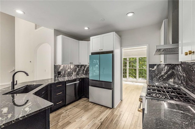 600 Oakmont Hl, Duluth, GA 30097 - kitchen featuring refrigerator, wall chimney exhaust hood, dishwashing machine, range, and dark stone countertops