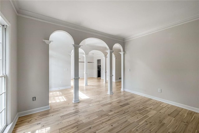 600 Oakmont Hl, Duluth, GA 30097 - empty room with ornate columns, crown molding, light wood finished floors, and arched walkways