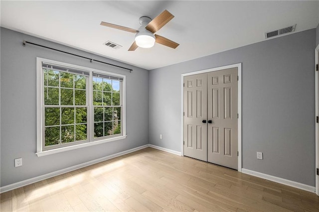 600 Oakmont Hl, Duluth, GA 30097 - unfurnished bedroom featuring light wood-type flooring, a closet, and ceiling fan
