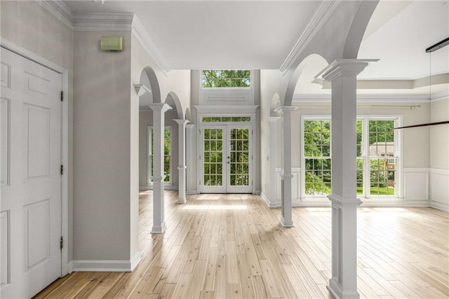 600 Oakmont Hl, Duluth, GA 30097 - entryway with decorative columns, light wood finished floors, crown molding, arched walkways, and french doors