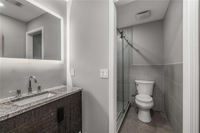 600 Oakmont Hl, Duluth, GA 30097 - bathroom with a stall shower, vanity, tile patterned flooring, and tile walls