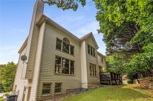600 Oakmont Hl, Duluth, GA 30097 - view of home's exterior with a chimney, a wooden deck, and a lawn