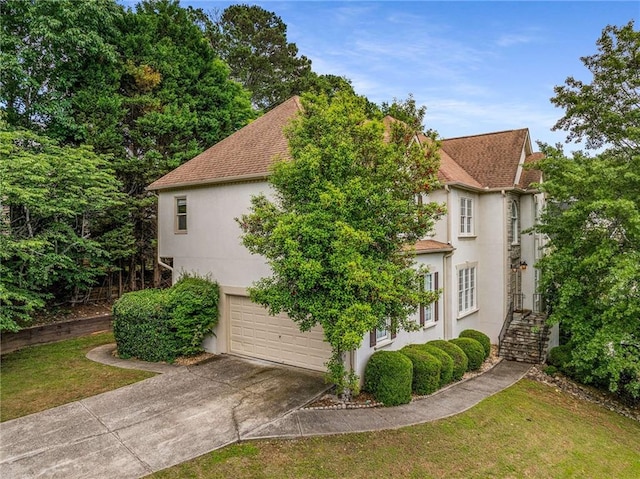 600 Oakmont Hl, Duluth, GA 30097 - view of side of property with stucco siding, concrete driveway, and an attached garage