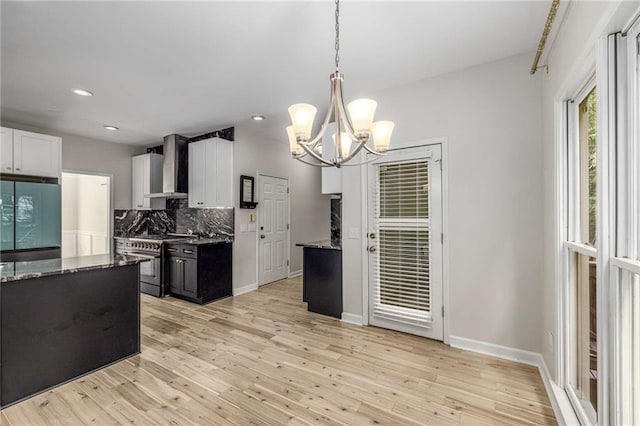 600 Oakmont Hl, Duluth, GA 30097 - kitchen with high end range, refrigerator, wall chimney exhaust hood, decorative backsplash, and dark stone countertops