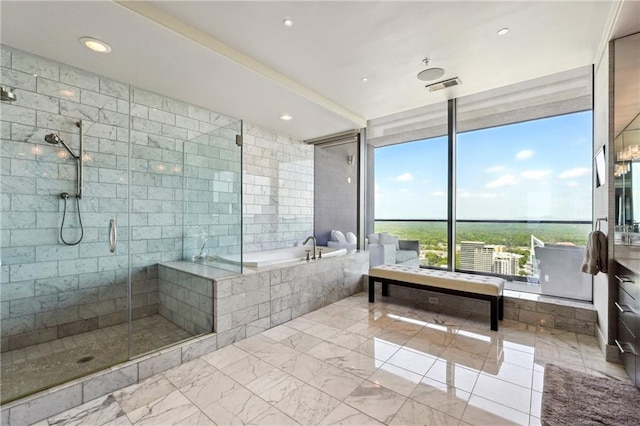 bathroom featuring plus walk in shower, a wall of windows, and plenty of natural light