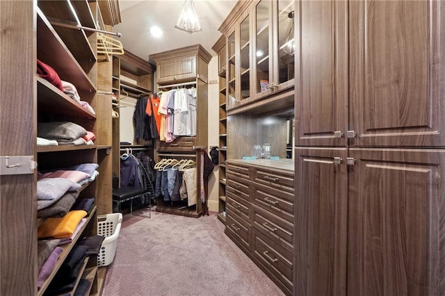 walk in closet featuring carpet floors