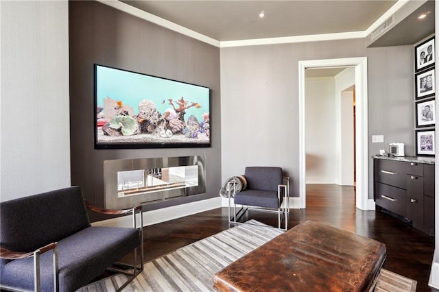 living area featuring ornamental molding and dark wood-type flooring