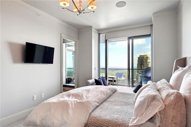bedroom featuring carpet flooring, access to exterior, ornamental molding, and a notable chandelier