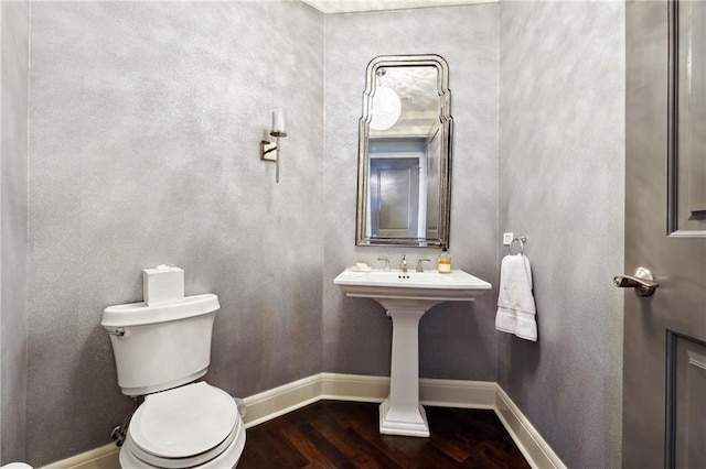 bathroom featuring wood-type flooring and toilet