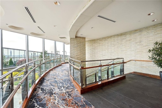corridor featuring plenty of natural light and floor to ceiling windows
