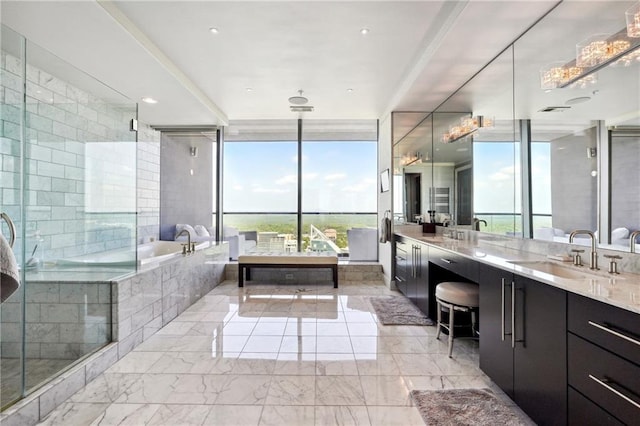 bathroom with separate shower and tub, vanity, and a wall of windows