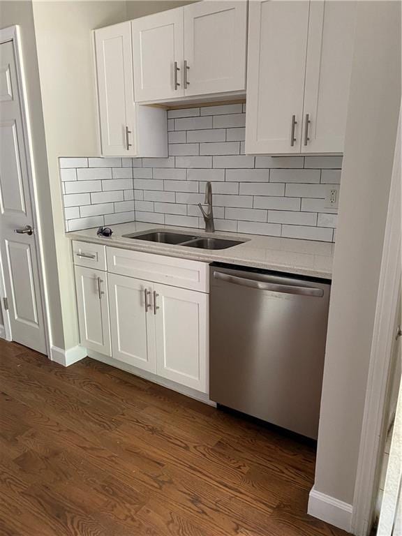 kitchen featuring dark hardwood / wood-style floors, dishwasher, sink, and white cabinets