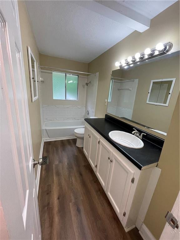 6399 Boca Grande Blvd, Forest Park, GA 30297 - full bath with wood finished floors, toilet, tub / shower combination, vanity, and a textured ceiling