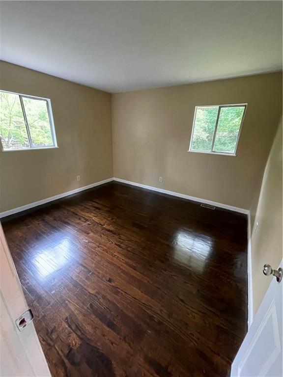 6399 Boca Grande Blvd, Forest Park, GA 30297 - spare room with dark wood-style flooring and baseboards