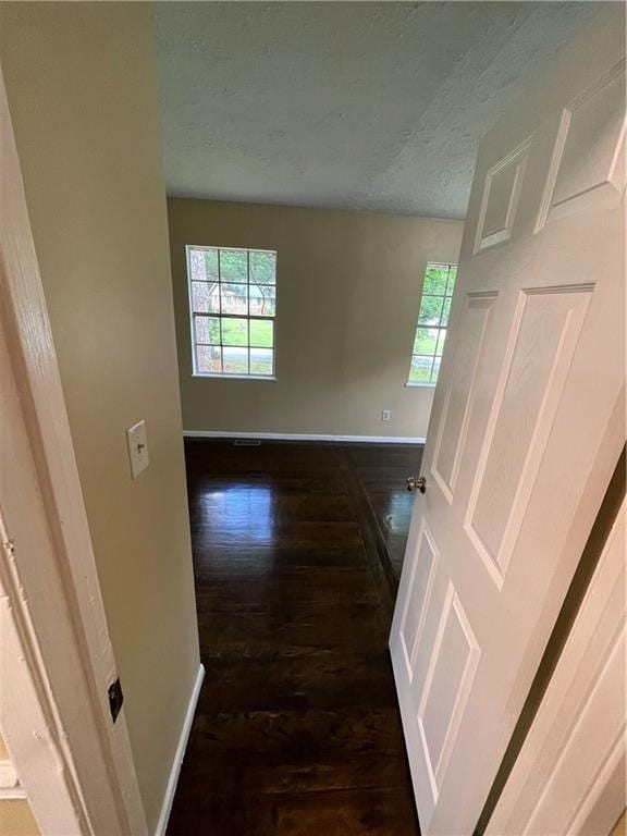 6399 Boca Grande Blvd, Forest Park, GA 30297 - empty room with baseboards, healthy amount of natural light, dark wood-style floors, and a textured ceiling