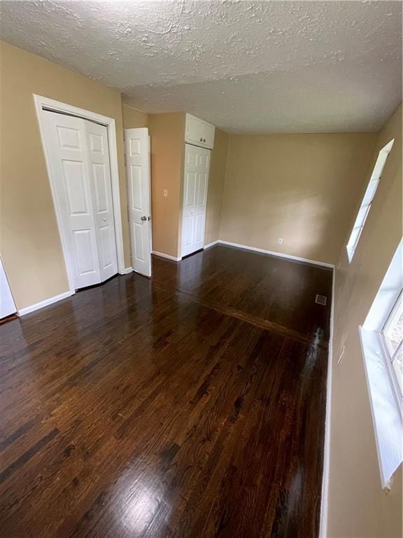 6399 Boca Grande Blvd, Forest Park, GA 30297 - empty room featuring dark wood-type flooring, a textured ceiling, and baseboards