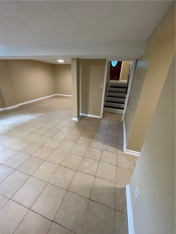 6399 Boca Grande Blvd, Forest Park, GA 30297 - finished basement with light tile patterned floors, stairway, and baseboards