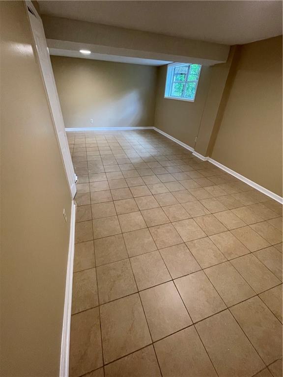 6399 Boca Grande Blvd, Forest Park, GA 30297 - below grade area featuring light tile patterned floors and baseboards