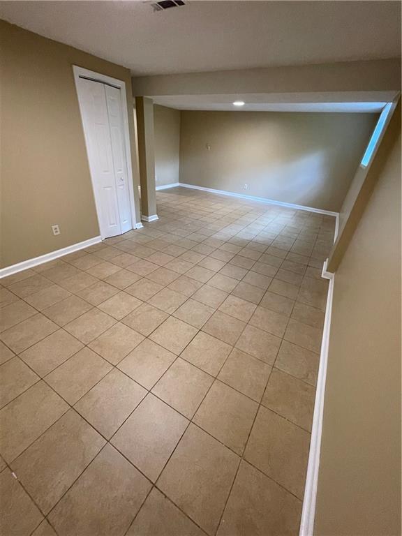6399 Boca Grande Blvd, Forest Park, GA 30297 - finished below grade area featuring light tile patterned floors and baseboards