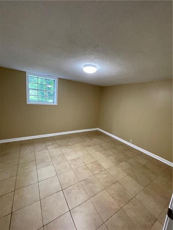 6399 Boca Grande Blvd, Forest Park, GA 30297 - empty room with a textured ceiling, baseboards, and light tile patterned floors