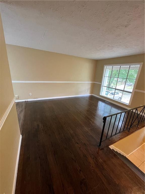 6399 Boca Grande Blvd, Forest Park, GA 30297 - spare room with wood finished floors, a textured ceiling, and baseboards