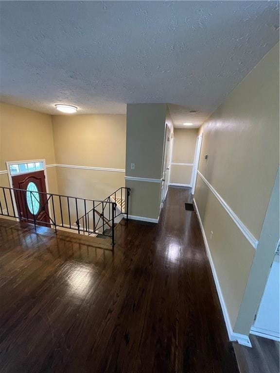 6399 Boca Grande Blvd, Forest Park, GA 30297 - hallway featuring an upstairs landing, a textured ceiling, wood finished floors, and baseboards