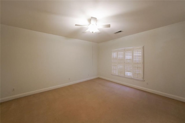 carpeted spare room with ceiling fan