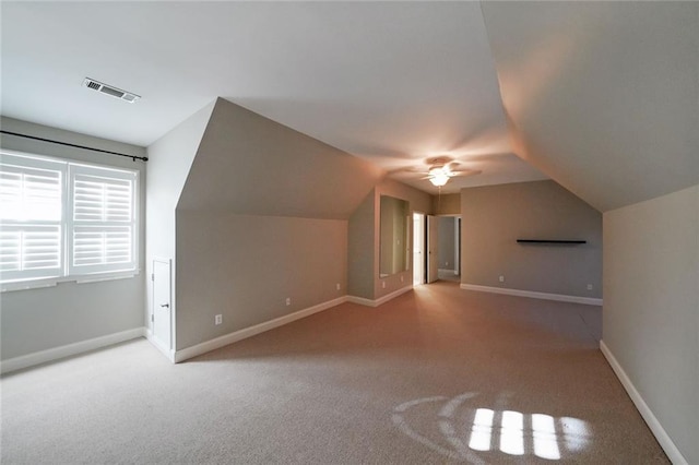 bonus room with ceiling fan, carpet flooring, and vaulted ceiling