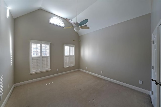 unfurnished room featuring high vaulted ceiling, light colored carpet, and a wealth of natural light