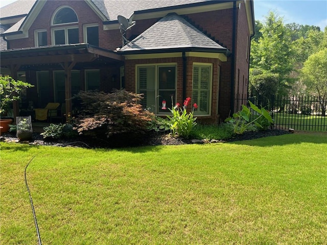 back of property with a lawn