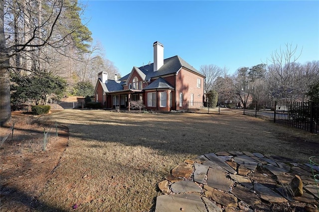 rear view of property with a lawn