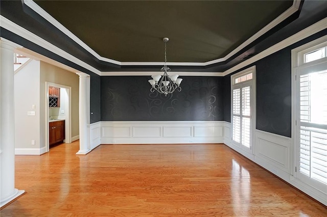 unfurnished dining area featuring a tray ceiling and crown molding