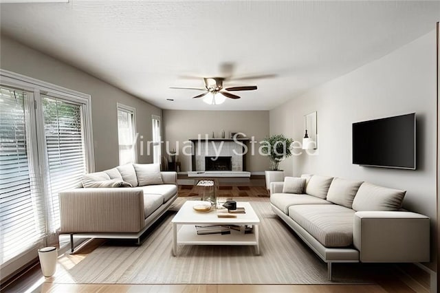 living room with ceiling fan and light hardwood / wood-style flooring