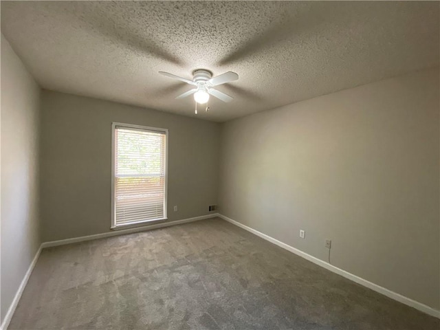 unfurnished room with carpet floors, a textured ceiling, and ceiling fan