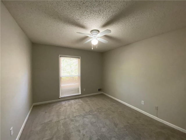 carpeted empty room featuring a textured ceiling and ceiling fan