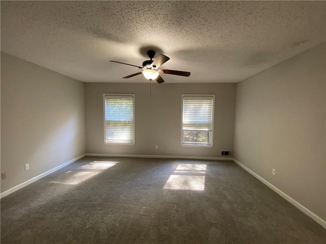 unfurnished room with ceiling fan, a textured ceiling, and dark colored carpet