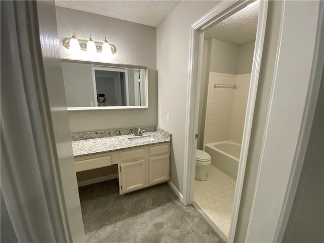 bathroom with vanity, tile patterned floors, a textured ceiling, and toilet