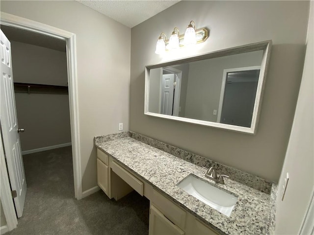 bathroom with vanity and a textured ceiling