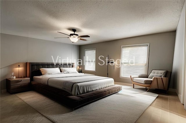 bedroom featuring a textured ceiling, light wood-type flooring, and ceiling fan