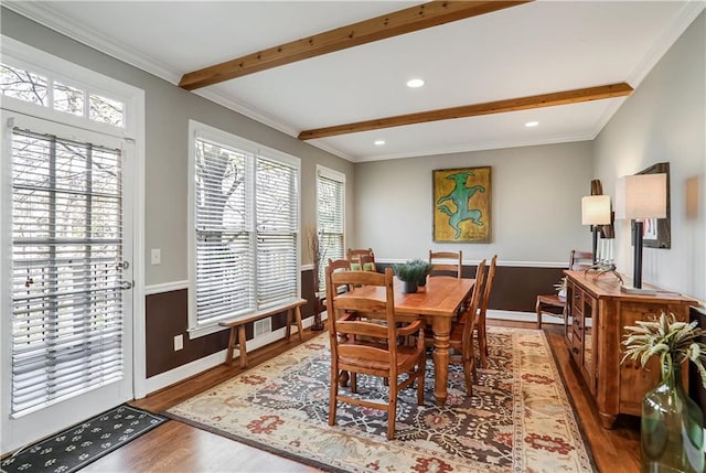 dining room with recessed lighting, wood finished floors, baseboards, beamed ceiling, and crown molding