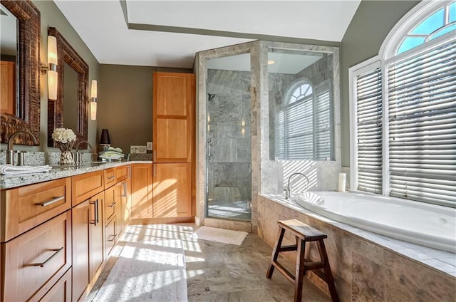 full bath featuring a bath, a shower stall, and vanity