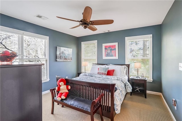 carpeted bedroom featuring visible vents, ceiling fan, and baseboards