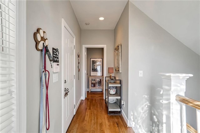 hallway with light wood-style floors, recessed lighting, and baseboards