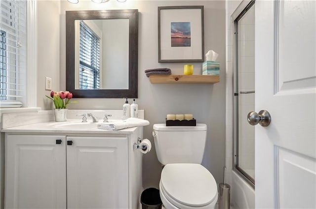 bathroom featuring shower / bath combination with glass door, vanity, and toilet