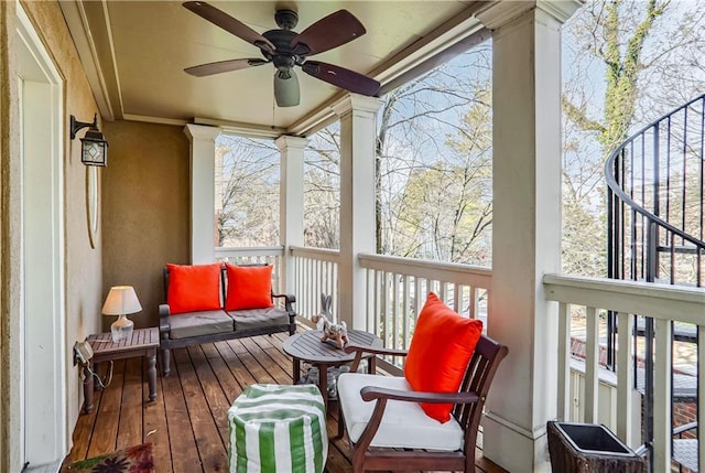 sunroom / solarium featuring a ceiling fan