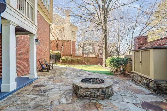 view of patio / terrace with a fire pit and a fenced backyard